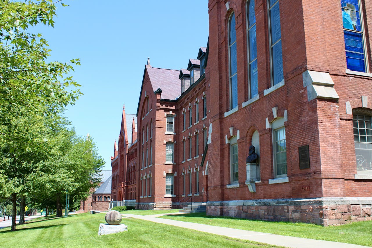A gothic architectural brick exterior of a Vermont university building on a sunny day.
