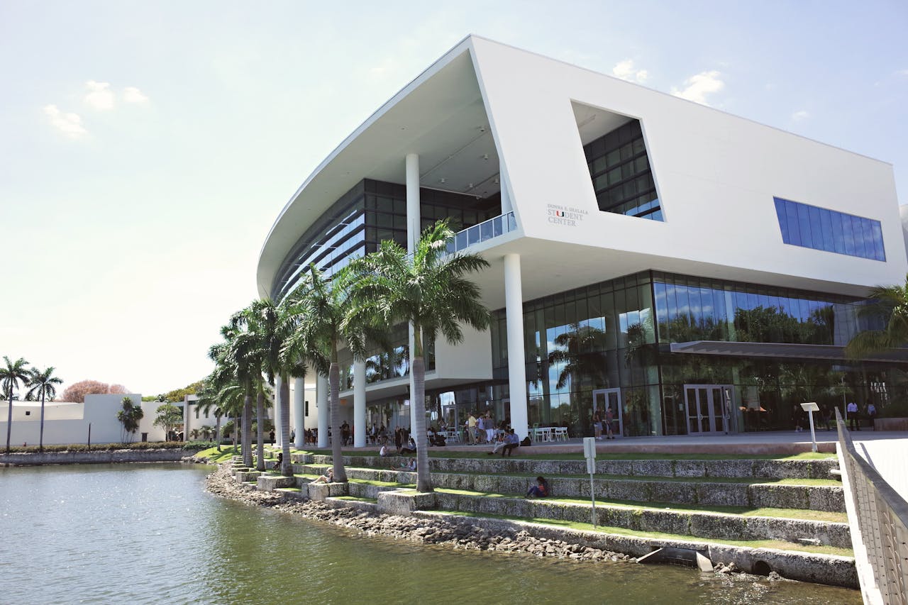 Stunning view of the modern architecture at University of Miami campus, reflecting on the water.